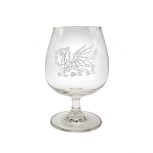 May include: A clear glass goblet with a white etched design of the Welsh dragon.