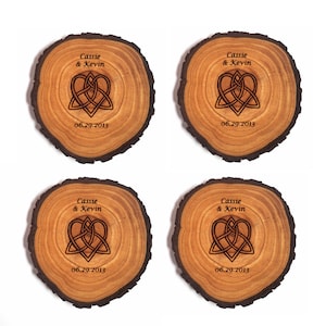 May include: Four wooden coasters with a Celtic knot heart design and the names "Cassie & Kevin" and the date "06.29.2013" engraved on each.