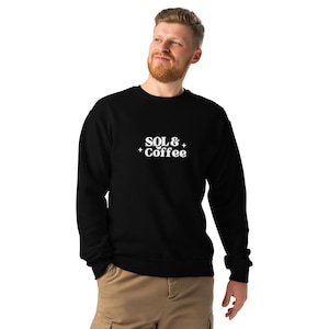 May include: Black crew neck sweatshirt featuring the white text "SQL & Coffee" with star details. The sweatshirt is worn by a person.