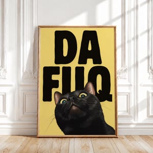 May include: A rectangular wall art print featuring a yellow background with the bold black text DA FUQ positioned above a black cat. The cat is looking upward with wide, yellow-green eyes, and the entire image is encased in a wooden frame.