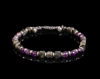 May include: A beaded bracelet featuring alternating faceted purple amethyst beads and grey square-cut labradorite stones. The beads are separated by small silver-toned metal spacers, and the bracelet includes an adjustable cord closure mechanism.
