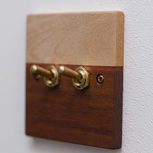 May include: A set of three ceramic mugs with a speckled, matte finish. The mugs are in shades of cream, light grey, and dark grey. Each mug has a simple, minimalist design, ideal for coffee or tea.