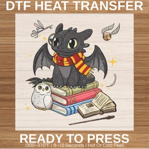 May include: DTF heat transfer featuring a black dragon with glasses and a scarf, sitting on books with an owl. A golden snitch, key, and wand are also present. The text "READY TO PRESS" is at the bottom.