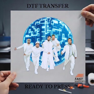 May include: A DTF transfer sheet featuring a graphic of four individuals dressed in white outfits standing in front of a glowing blue digital sphere. The text DTF TRANSFER is at the top and READY TO PRESS is at the bottom, with a FAST SHIPPING logo.