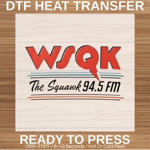 May include: A DTF heat transfer featuring the text "WSQK The Squawk 94.5 FM" in red and black. The design is on a white background with a wood grain texture. The words "READY TO PRESS" are at the bottom.
