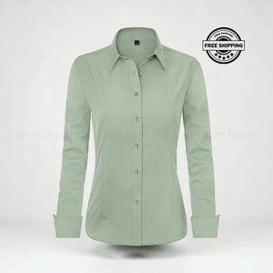 May include: A sage green long-sleeve button-down shirt featuring a classic collar, a front button placket, and cuffs. The shirt has a tailored fit with vertical seams on the front. The text "Womens Dress Shirts Long Sleeve Button Down" is visible.