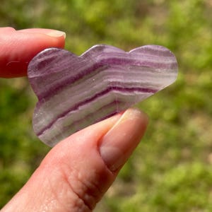 May include: A rustic wooden sign with the text "Welcome to our home" in white lettering. The sign features a distressed finish and a simple, inviting design, perfect for front door decor.