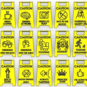 May include: A collection of yellow caution signs with black text and illustrations. Signs include "Needs Coffee," "Genius at Work," "Needs to Nap," "Not in the Mood," and "Parental Sanity 2%." Other signs include "Drinking with the Boys," "Drinking with the Girls," "Pooping," "Hangry," and "Toddler Unleashed."