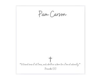 May include: A white card with the name "Pam Carson" in cursive script. Below, a cross symbol and a quote from Proverbs 17:17: "A friend loves at all times, and a brother is born for a time of adversity."