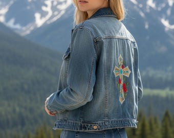 Maison Jules brand woman’s blue denim jacket upcycled unique circle rivet design on sleeves and shoulders embroidered cross w/ roses on back
