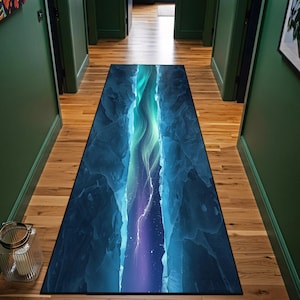 May include: A rectangular hallway rug featuring a vibrant design of a deep blue canyon with turquoise and purple highlights. The rug's design evokes a sense of depth and natural beauty, suitable for home decor.