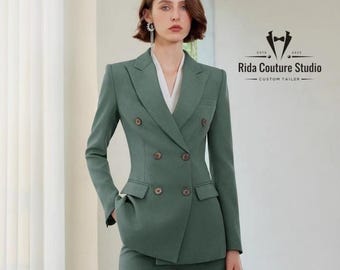 May include: A sage green double-breasted suit with matching trousers. The suit features a tailored fit, visible buttons, and a white collared shirt underneath. The image includes the text "Rida Couture Studio - Custom Tailor".