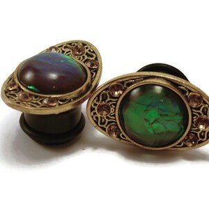 Pair of Round Multi-colored resin with gems attached to Black Flare Acrylic Plugs 1/2” with silicone O-ring