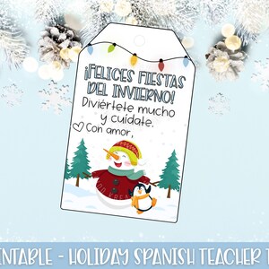 May include: A white tag with a snowman and penguin illustration, festive lights, and Spanish text. The tag reads "Happy Winter Holidays! Have fun and take care. With love." The bottom of the tag says "Printable - Holiday Spanish Teacher Tag."