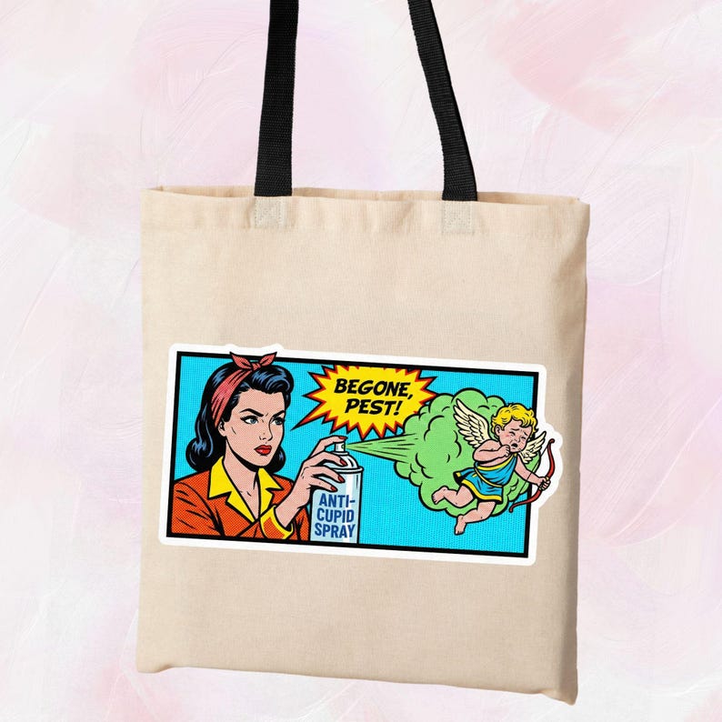 May include: A beige tote bag featuring a pop art style graphic. The graphic depicts a woman spraying "Anti-Cupid Spray" at a cherub with a bow and arrow. Text in the image reads "Begone, Pest!"