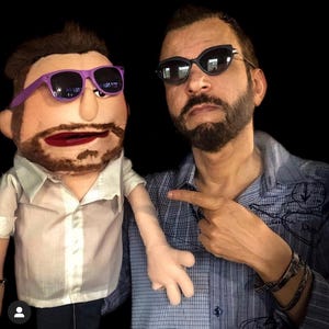 May include: A white ceramic mug with a black handle and the text "But First, Coffee" in a bold, black font. The mug is sitting on a wooden surface. The mug is approximately 4 inches tall.