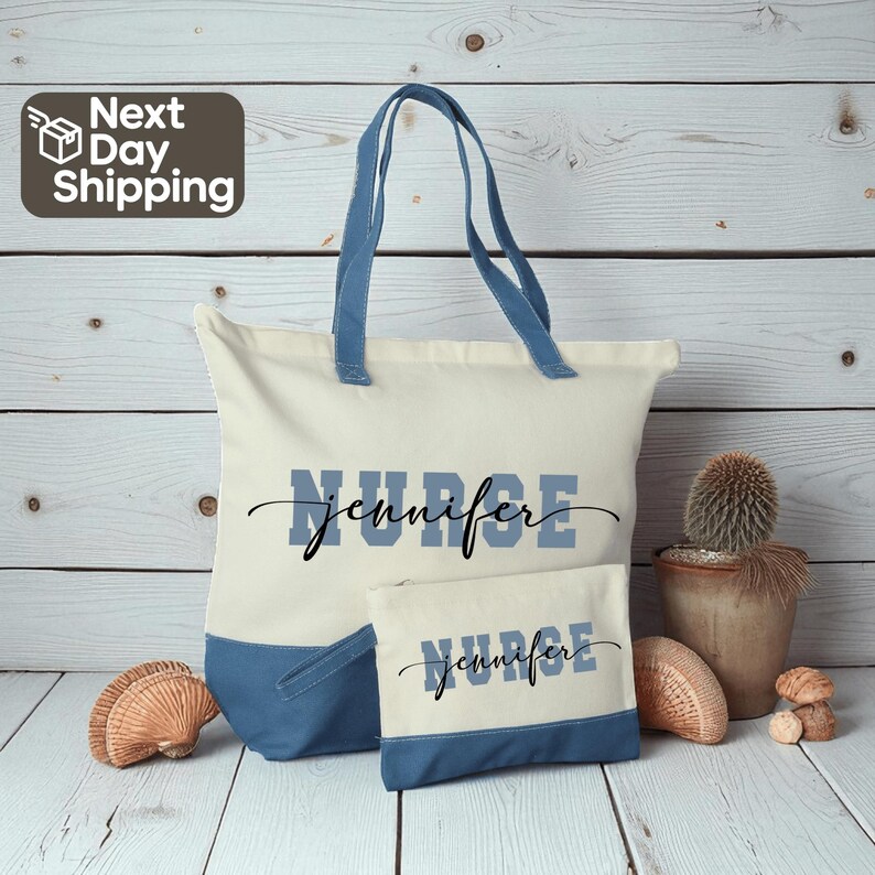 A tote bag with the name "Jennifer" printed on it, along with a smaller bag, both sitting on a wooden surface. There is also a potted plant and some seashells nearby.