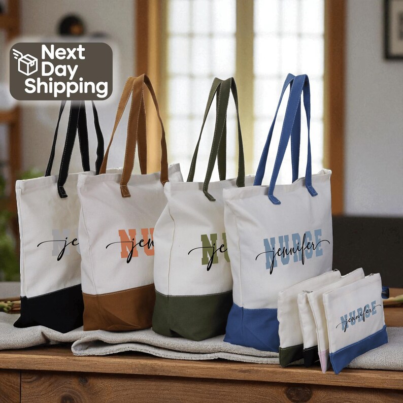 a collection of colorful tote bags with personalized names printed on them, arranged on a wooden surface.