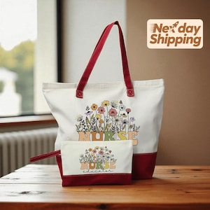 May include: A white tote bag and matching pouch with a floral design and the word "NURSE" in colorful letters. The tote bag has red handles and a red base. The pouch has a red base and the words "NURSE educator".