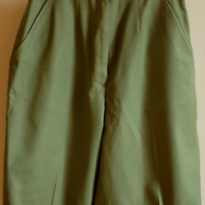 May include: A pair of olive green shorts with a high waist and two front pockets.
