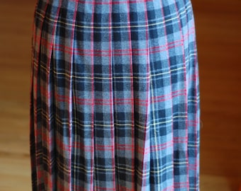 May include: A pleated skirt with a plaid pattern in shades of blue, black, red, and yellow.
