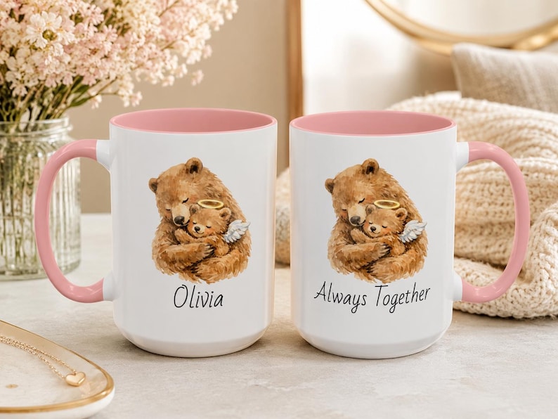 Pink handle pregnancy loss memorial mug with watercolor bear holding angel baby bear, personalized with Olivia and Always Together, styled on a soft neutral bedside table.