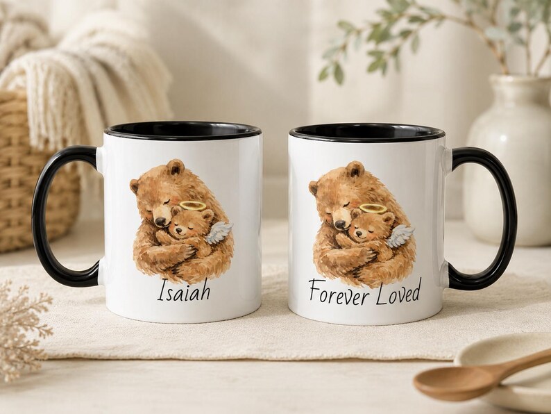 Black handle baby loss memorial mug set with watercolor angel baby bear design, personalized with Isaiah and Forever Loved, styled on a warm neutral tabletop.
