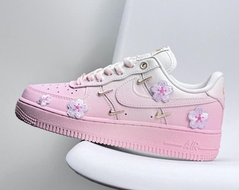 Handcrafted pink Air Force 1 sneakers with custom flowers.