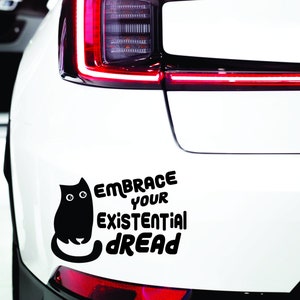 May include: Black and white car sticker with a black cat and the text "Embrace your existential dread".