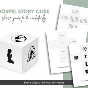 Puede incluir: Un cubo blanco de Gospel Story con ilustraciones negras de la Tierra, una figura orando y un sepulcro vacío. El cubo está acompañado de tarjetas impresas con gráficos y texto relacionados. El texto del cubo dice "GOSPEL STORY CUBE" y "share your faith confidently."