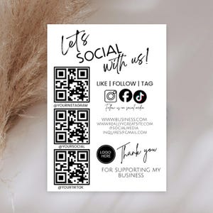 May include: White card with black text and QR codes. The text reads "Let's Social With Us!" and includes social media icons for Instagram, Facebook, and TikTok. It also displays website and email information, and says "Thank you for supporting my business."