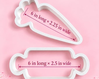 May include: Two white plastic cookie cutters. The top cutter is shaped like a carrot and measures 6 inches long by 2.25 inches wide. The bottom cutter is shaped like a rolling pin and measures 6 inches long by 2.5 inches wide. Text reads Doll Face Delights LLC.