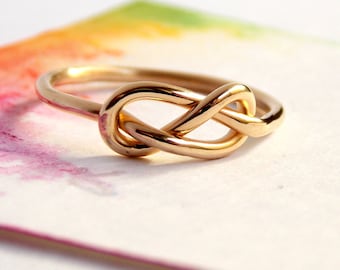 Gold Infinity Knot Ring made from 14K Gold-filled: A golden ring perfect for a love knot promise ring.