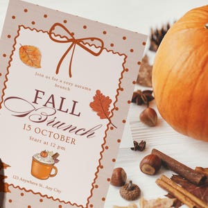 May include: A fall brunch invitation with a decorative border, bow, and fall leaves. The invitation includes the text "FALL Brunch 15 OCTOBER" and a drawing of a mug of hot chocolate. An orange pumpkin and fall spices are in the background.