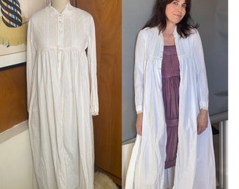 May include: A white cotton nightgown with long sleeves and a button-up front. The gown has a gathered waist and a ruffled collar.