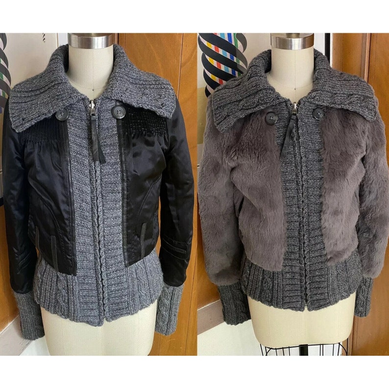 May include: Two cropped images of a grey knit jacket with a black zip and a black collar. The jacket on the left has a black satin panel on the front. The jacket on the right has a grey faux fur panel on the front.
