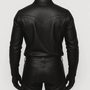 May include: Black leather jacket and matching pants. The jacket has a pointed yoke design on the back and long sleeves. The pants have a classic five-pocket design. The outfit is worn with black gloves.