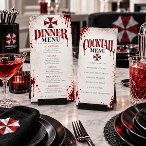 May include: Two rectangular menu cards titled Dinner Menu and Cocktail Menu, featuring the Umbrella Corporation logo and red blood splatter designs. The menus list various themed food and drink items on a white background with black text.