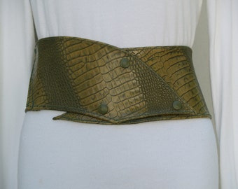 May include: A green faux crocodile skin belt with a unique angled design and metal accents.