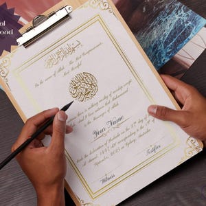 May include: A certificate on a wooden clipboard with gold decorative borders and Arabic calligraphy. The text "Digital Download" is in the upper left corner. A hand is holding a black pen, writing on the certificate.