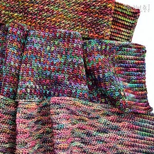May include: A colorful, handmade crochet scarf with a textured stitch pattern. The scarf features a vibrant mix of colors, including pink, purple, green, and orange. The scarf is made of soft yarn and is perfect for keeping warm during the colder months.