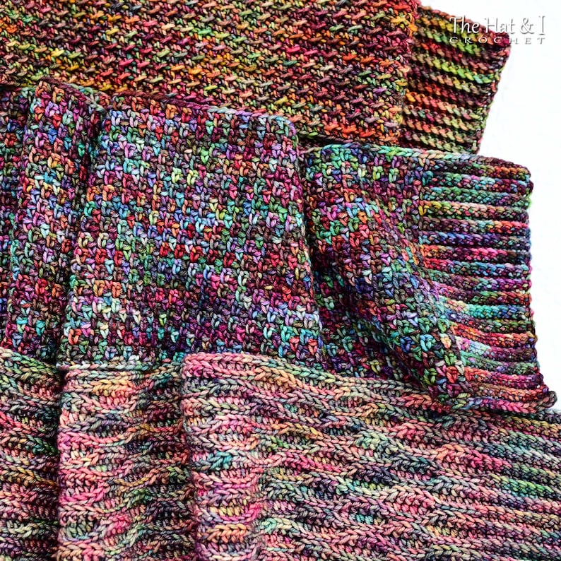 May include: A colorful, handmade crochet scarf with a textured stitch pattern. The scarf features a vibrant mix of colors, including pink, purple, green, and orange. The scarf is made of soft yarn and is perfect for keeping warm during the colder months.