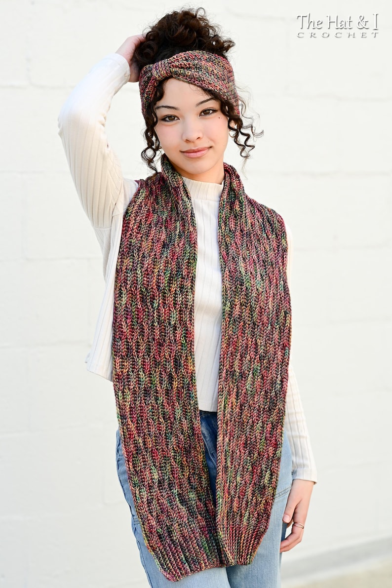 May include: A multi-colored knitted scarf and matching headband. The scarf is long and features a textured pattern with hues of red, green, and purple. The headband has a similar design. The text "The Hat & I Crochet" is visible in the upper right corner.