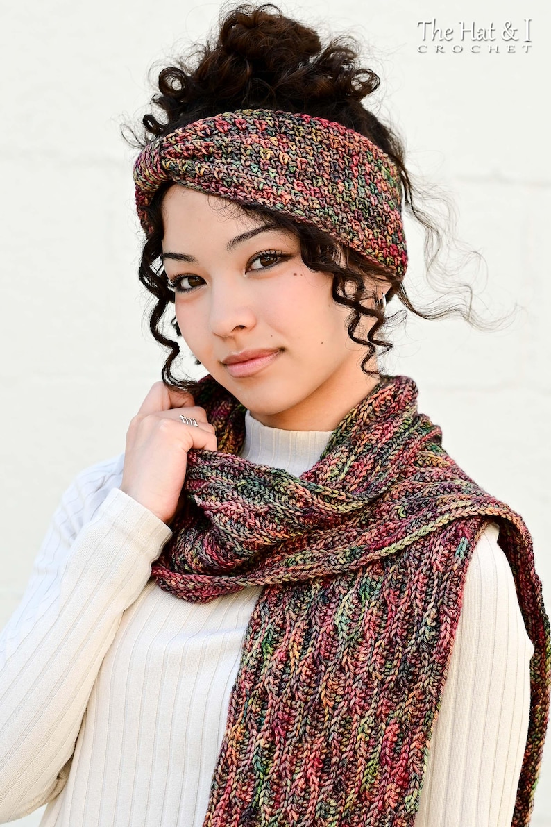 May include: A multi-colored knit headband and scarf set. The headband is wrapped around the head, and the scarf is draped around the neck. The set is made of a yarn with red, green, and yellow hues. The text "The Hat & I Crochet" is in the upper right corner.