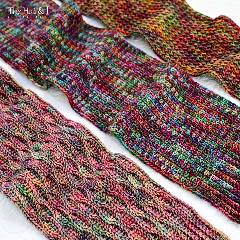 May include: Close-up of three pairs of colorful, handmade crochet socks. The socks feature a mix of vibrant colors including pink, green, purple, and orange. The socks are displayed on a white surface. The Hat & I Crochet logo is in the top left corner.