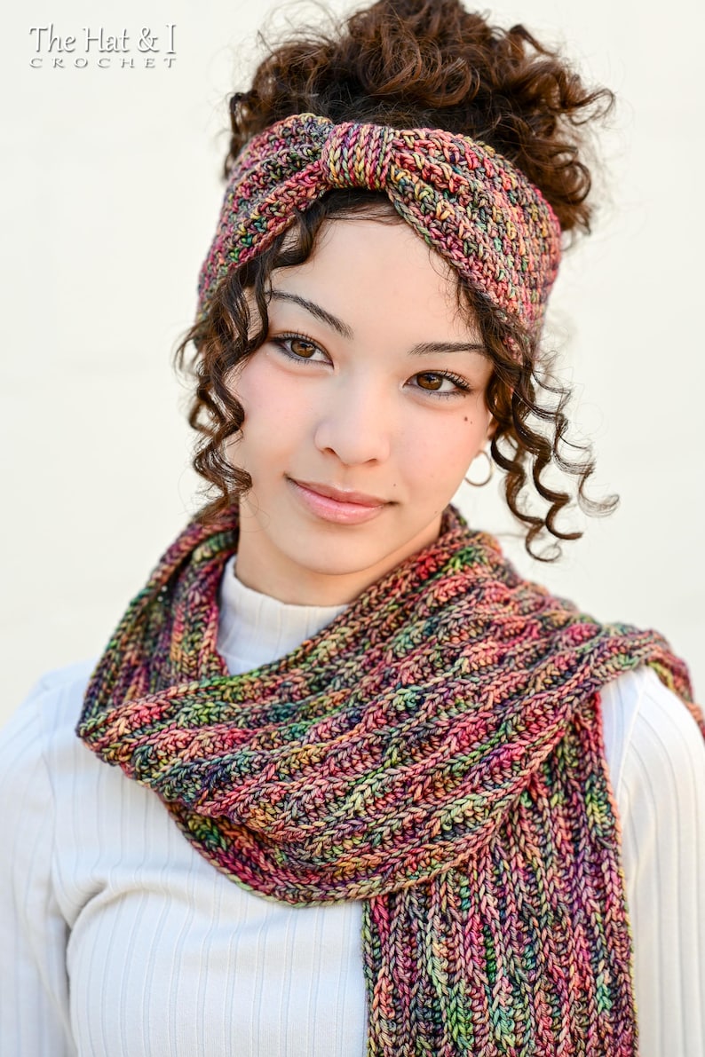 May include: A colorful, hand-knitted headband and scarf set. The headband is a knotted style, and the scarf is a cowl. The set features a mix of pink, green, yellow, and blue yarns. The text "The Hat & I Crochet" is in the top left corner.