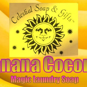 May include: A yellow and gold label with a sun and stars design. The label reads "Celestial Soap & Gifts". Below the label is the text "Banana Coconut Magic Laundry Soap" in pink and yellow letters.