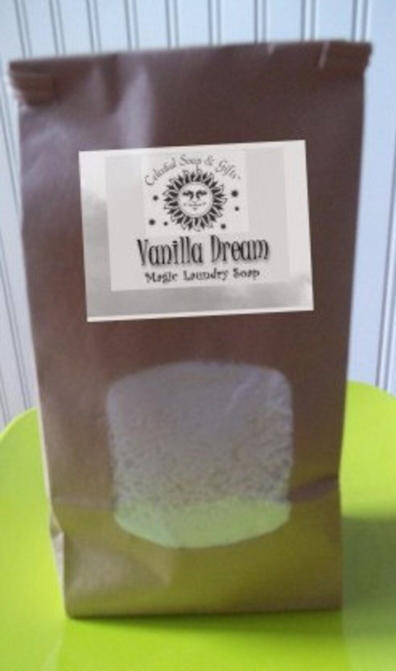 May include: A brown paper bag with a white label that says "Celestial Soap & Gifts" and "Vanilla Dream Magic Laundry Soap". The label has a sun with a face on it.