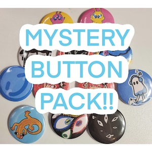 May include: A collection of colorful round buttons with various cartoon designs. The buttons feature images of creatures, eyes, and abstract shapes. The text "MYSTERY BUTTON PACK!!" is displayed in a blue font across the image.