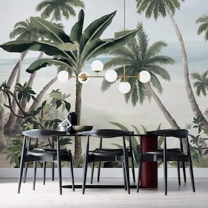 May include: A dining room scene featuring a black table and chairs set against a tropical mural. A gold and white globe light fixture hangs above the table. The mural depicts palm trees and a beach scene.